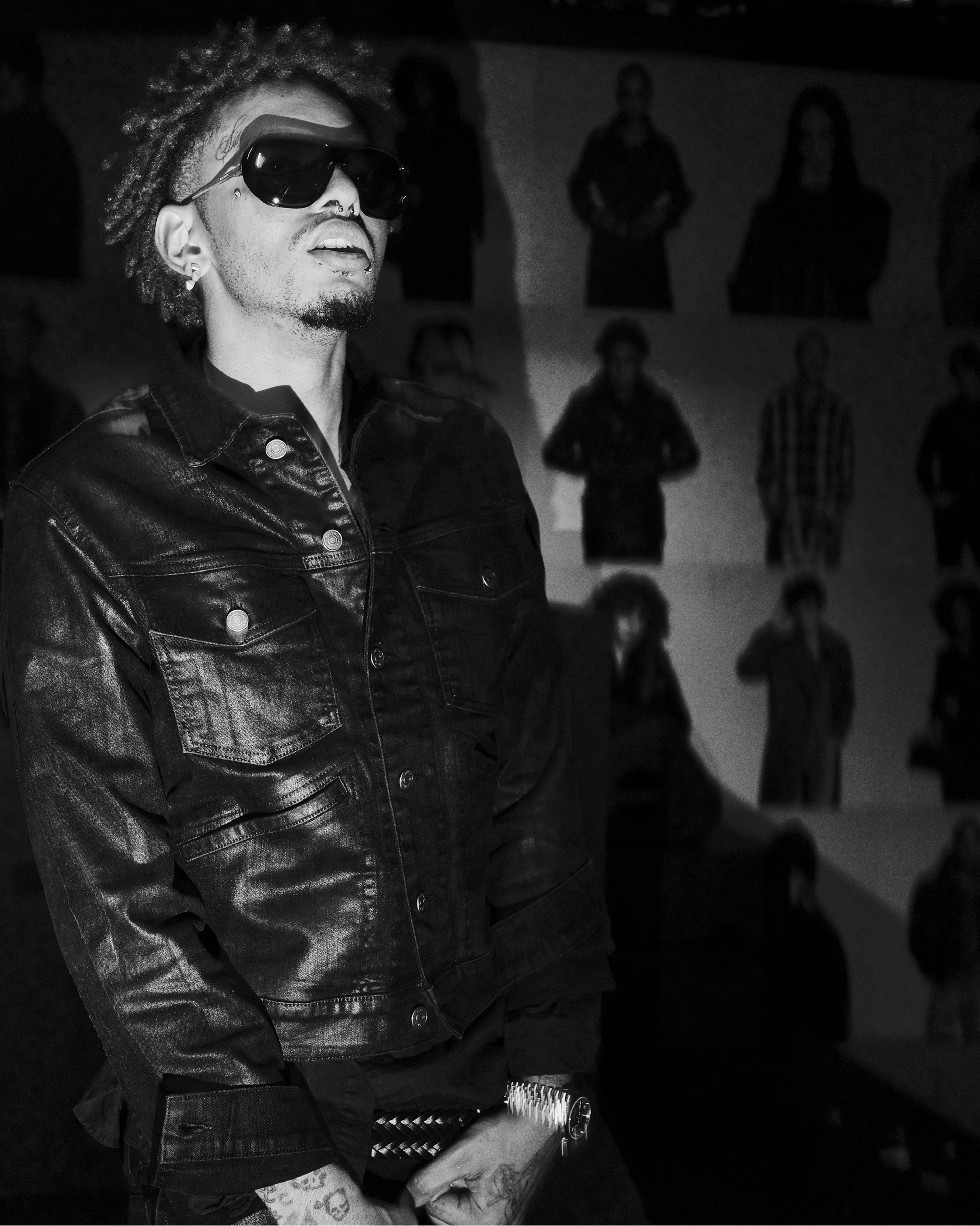 Black-and-white portrait of a guest wearing sunglasses and a leather jacket at the AllSaints Autumn Winter 26 Launch Party.