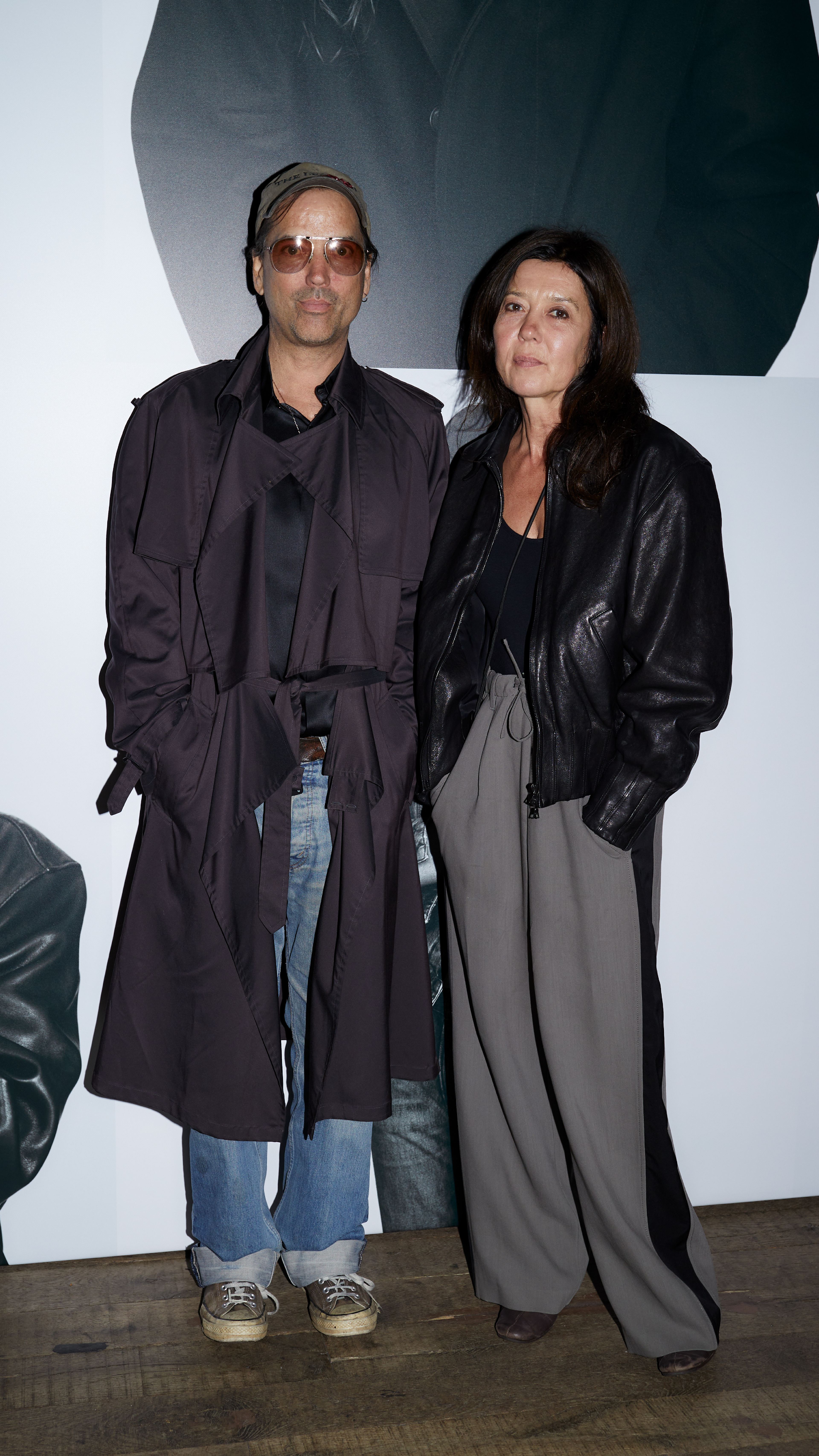 Two guests posing together in dark outerwear at the AllSaints Autumn Winter 26 Launch Party.
