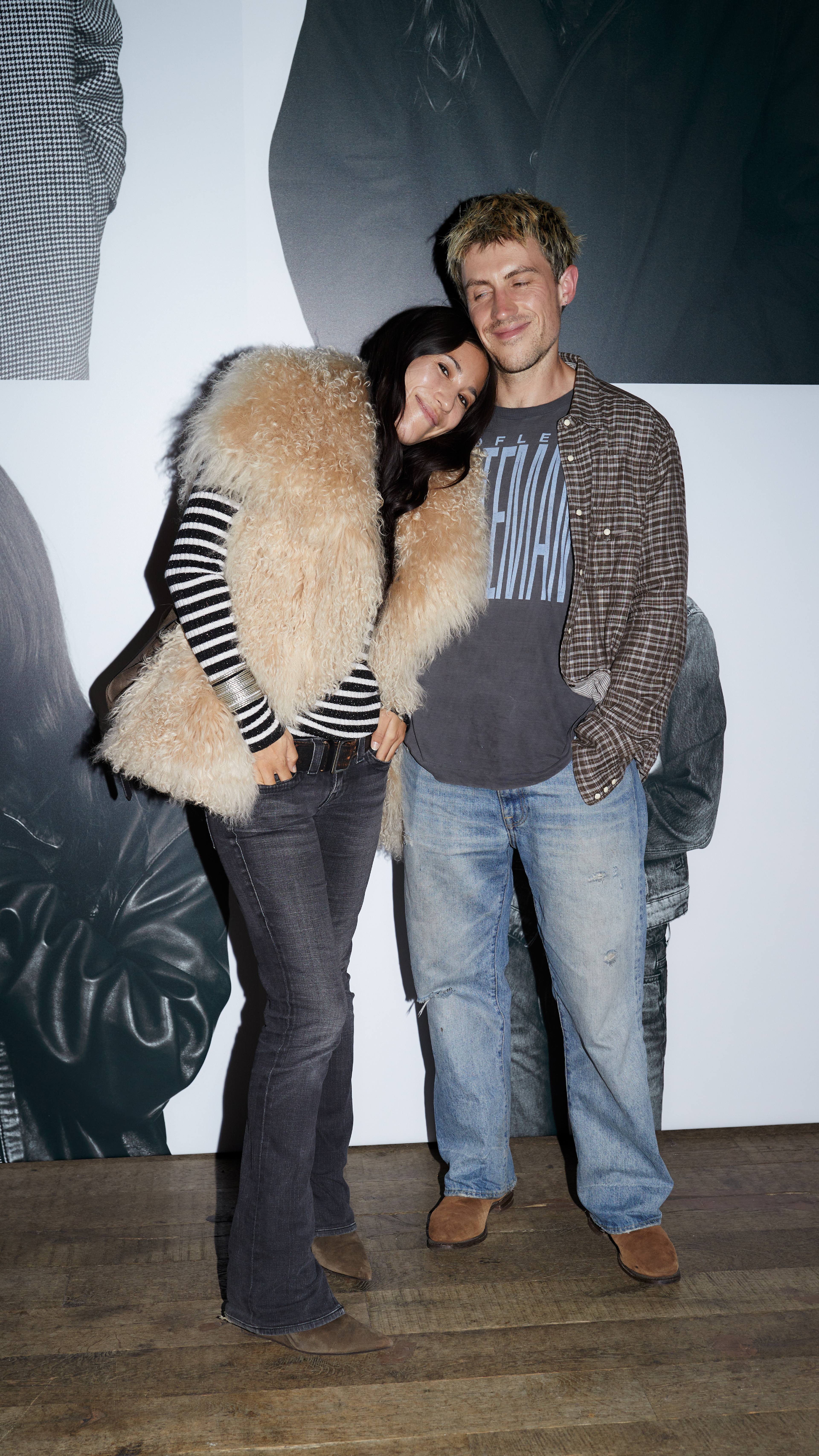 Two guests posing together in layered casual looks at the AllSaints Autumn Winter 26 Launch Party.